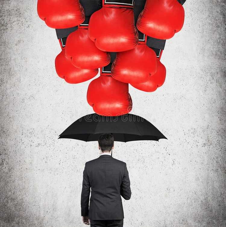 Stress and coping theorya small businessman holding a red umbrella to hide from a large boxing glove on a spring arm